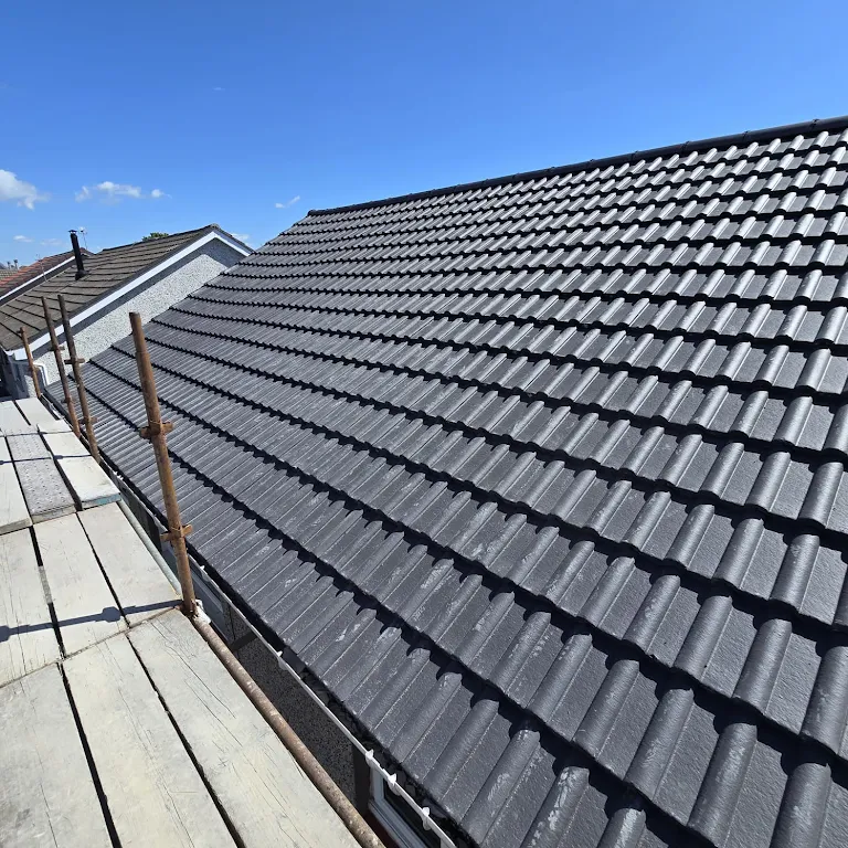 Roofer working on a pitched UK slate roof in Hereford